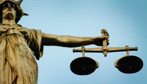 A statue holding the scales of justice is seen on top of the Old Bailey in London, on December 12, 2003.