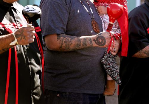 Agua Caliente Band of Cahuilla Indians bird singer Joseph Saubel holds his daughter, Elise Saubel, 2, during a renaming ceremony of the main Post Office to the Richard M. Milanovich branch, in Palm Springs, Calif., on Thursday, November 7, 2024.