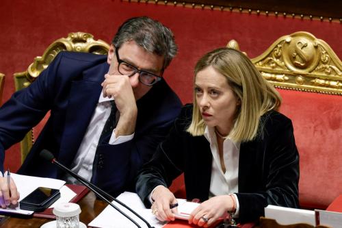 Italy's Prime Minister Giorgia Meloni talks with Economy Minister Giancarlo Giorgetti, as she appears at the upper house of the Parliament in Rome, ahead of a European Union leaders' summit, in Rome, Italy, March 18, 2025.