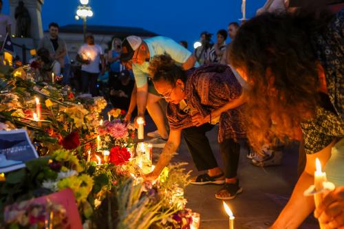 Mourners lay down candles during a candlelight vigil outside the Minnesota State Capitol following the assassination of State Representative Melissa Hortman and her husband, Mark Hortman. Amid a concerning trend of political violence in the U.S., the Hortmans were shot at their home on June 14, 2025.
