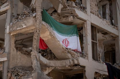 An Iranian flag hangs on a building targeted during Israeli attacks on a residential area in Tehran, Iran, on August 11, 2025, following the ceasefire between Iran and Israel after the 12-day war. (Photo by Morteza Nikoubazl/NurPhoto)