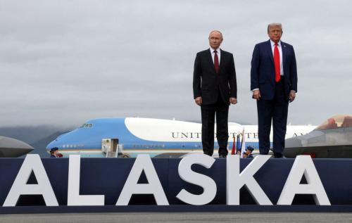 Russian President Vladimir Putin and U.S. President Donald Trump pose on a podium on the tarmac after they arrived to attend a meeting at Joint Base Elmendorf-Richardson in Anchorage, Alaska, U.S., August 15, 2025.