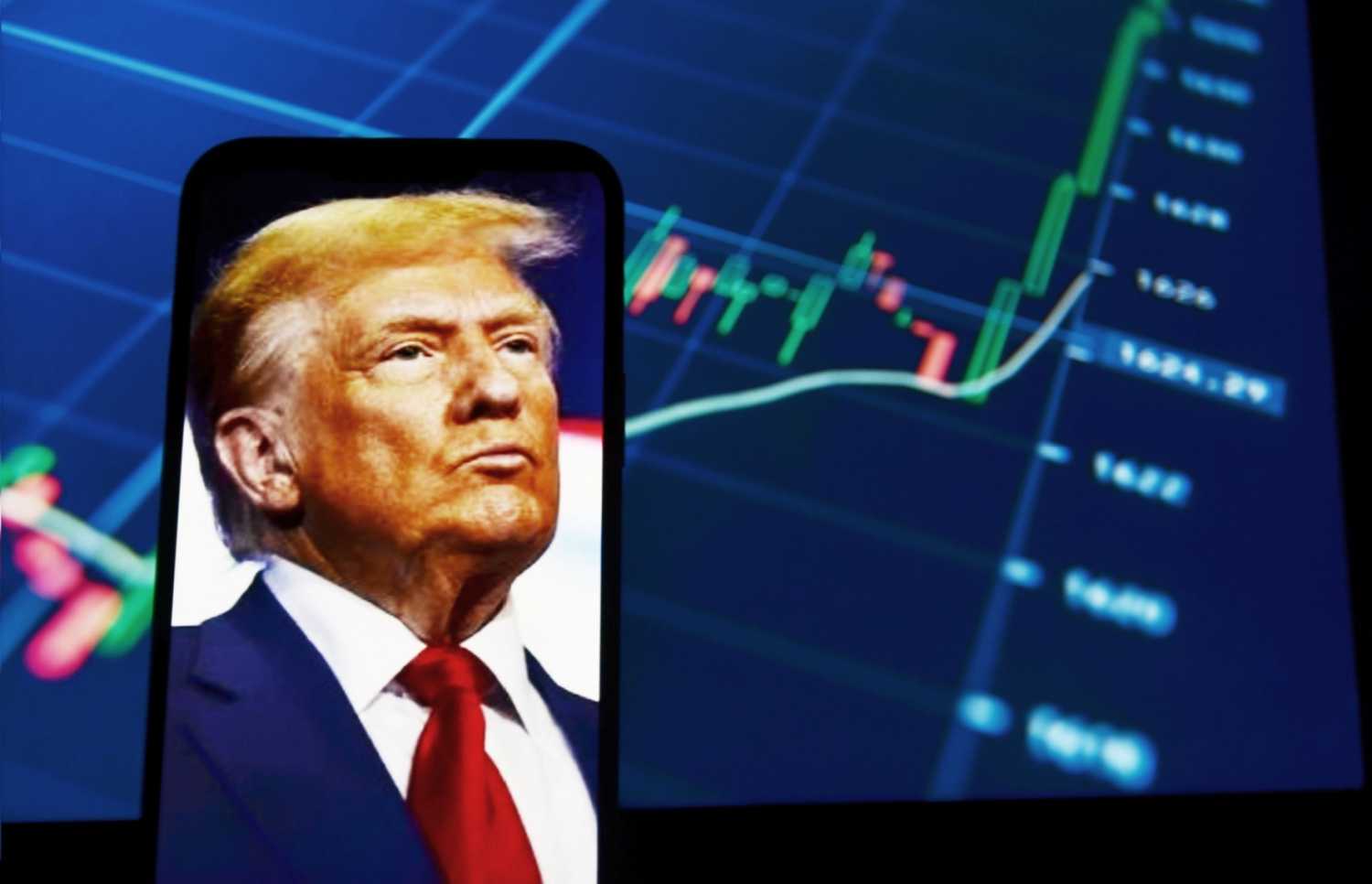 Picture of Donald Trump on a smart phone in front of a bar graph.