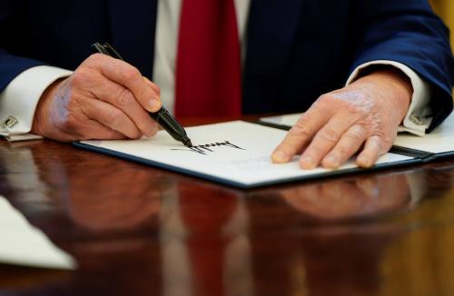 U.S. President Donald Trump signs executive orders in the Oval Office at the White House in Washington, U.S., January 30, 2025.