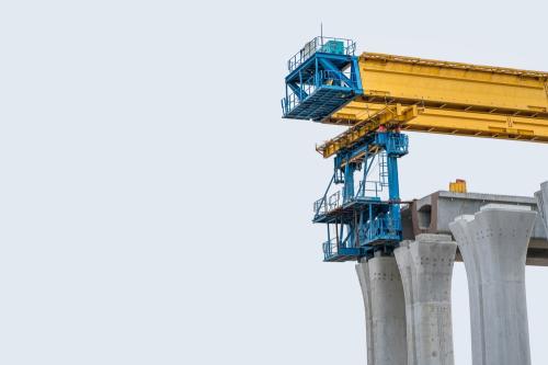 Bridge Girder Launcher Under Construction,Bridge construction,segmental bridge box girders ready for construction,segments of long span bridge box girder on white background.