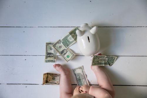 Financial,Planning.,Legs,Of,A,Baby,With,Dollar,Bills,And