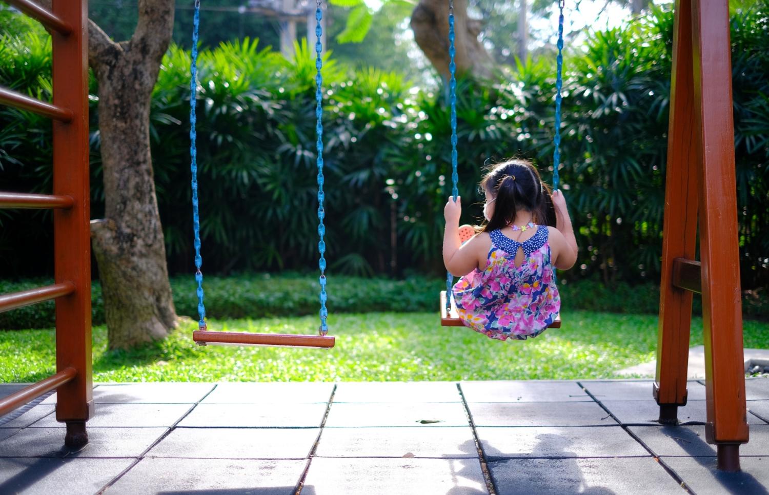 A girl alone on a swing.