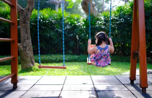 A girl alone on a swing.