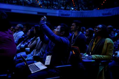 An attendee takes a photograph during a keynote on the second day of the annual Facebook F8 developers conference in San Jose, California, U.S., April 19, 2017. REUTERS/Stephen Lam