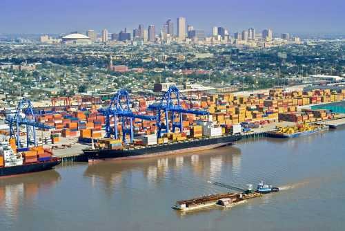 Aerial of New Orleans port activity with cityscape