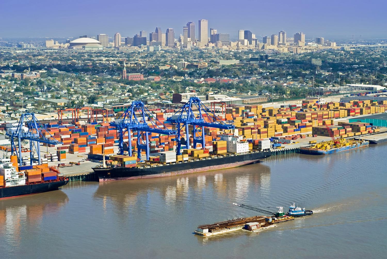 Aerial of New Orleans port activity with cityscape
