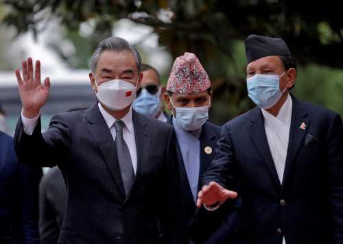 Nepal’s Foreign Minister Narayan Khadka and his Chinese counterpart Wang Yi wave to the media before their meeting in Kathmandu, Nepal, March 26, 2022.