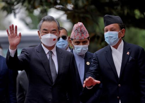 Nepal’s Foreign Minister Narayan Khadka and his Chinese counterpart Wang Yi wave to the media before their meeting in Kathmandu, Nepal, March 26, 2022.