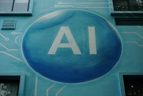 A mural on the side of a building with "AI" written in the center of a blue sphere.