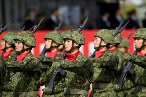 Members of the Japan Self-Defense Forces (JSDF) march in formation at Ground Self-Defense Force Camp Asaka, November 9, 2024 in Asaka, Japan, as Japanese Prime Minister Shigeru Ishiba (not pictured) reviews troops of the country's Self-Defense Forces for its 70th Anniversary.