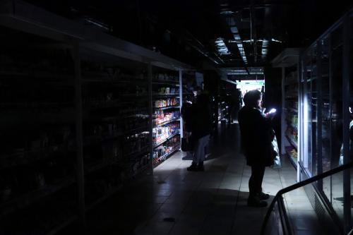 Customers use camera flashes in a supermarket during a power outage in Kyiv, Ukraine, on November 27, 2024.