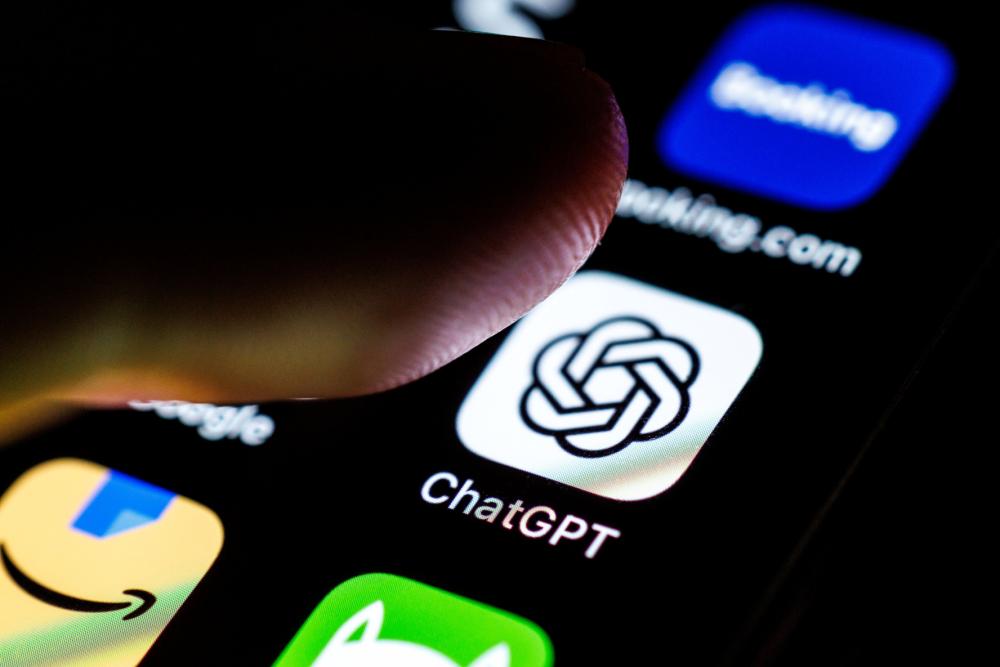 The logo of the ChatGPT app can be seen on the display of a smartphone on September 2, 2025, while an index finger approaches the application's icon.