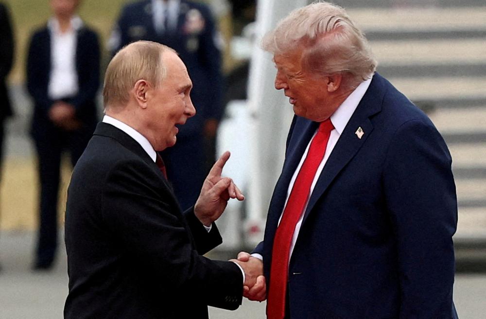 U.S. President Donald Trump shakes hand with Russian President Vladimir Putin, as they meet to negotiate for an end to the war in Ukraine, at Joint Base Elmendorf-Richardson in Anchorage, Alaska, U.S., August 15, 2025.