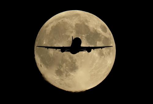 A passenger plane passes in front of the first supermoon of the year, known as the Harvest Moon, as it flies above London, Britain, October 6, 2025.