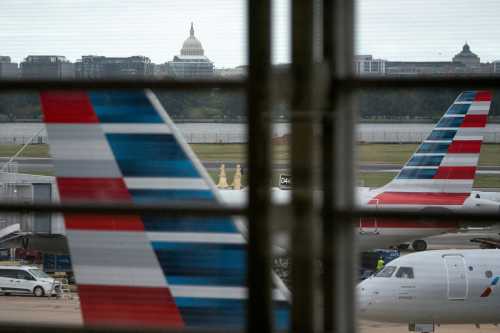 American Airlines flights stage on the tarmac at Reagan Washington National Airport as the U.S. government shutdown continues in Arlington, Virginia, U.S., on Oct. 8, 2025.