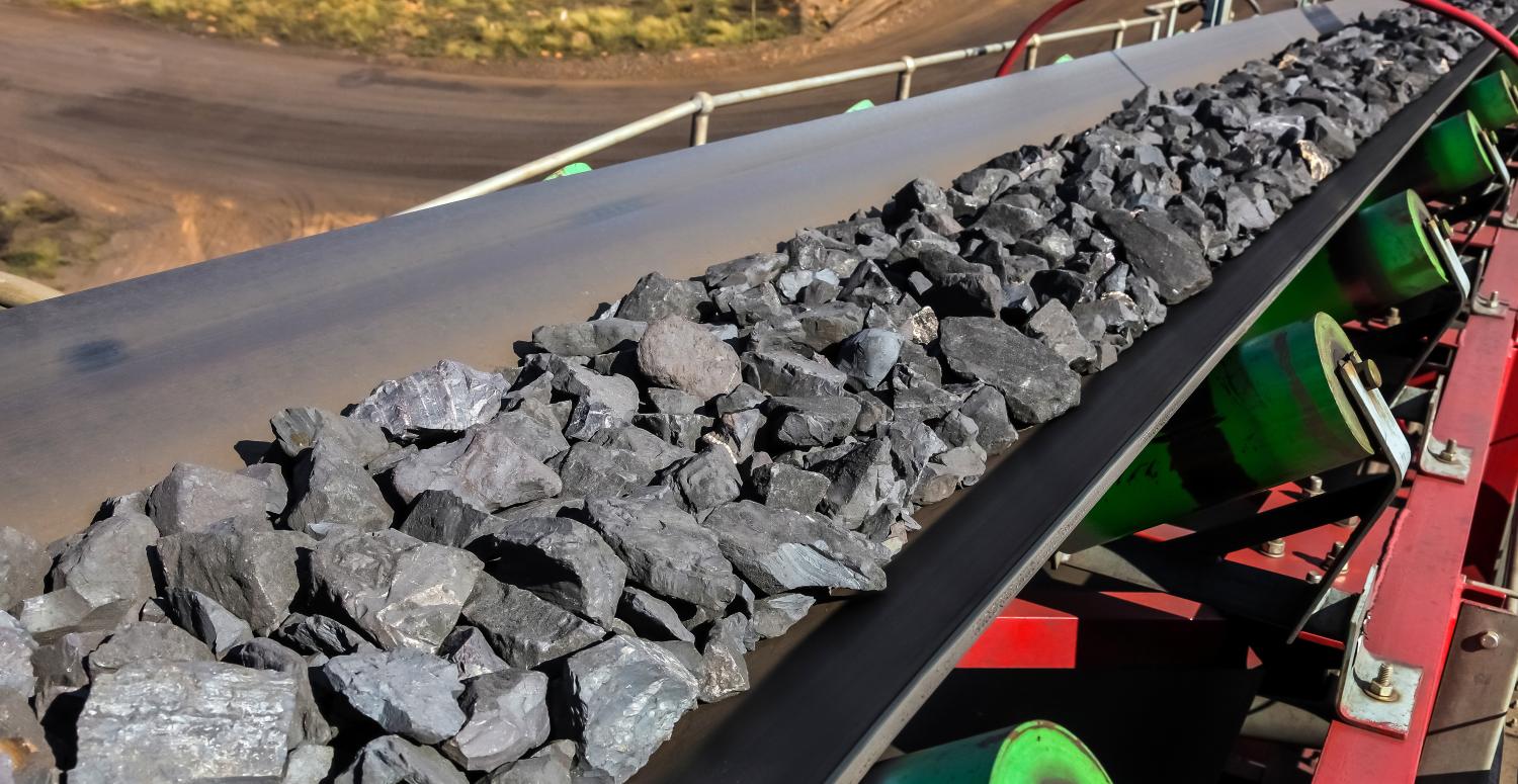 Close up of Manganese rock being moved on a conveyor belt