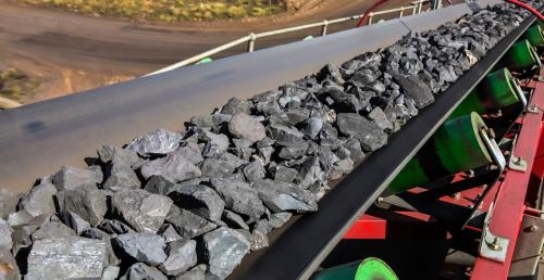 Close up of Manganese rock being moved on a conveyor belt