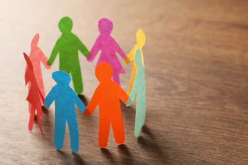 Paper cutouts of people hold hands in a circle