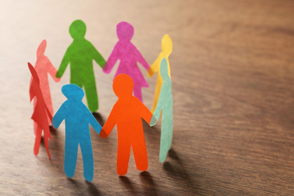 Paper cutouts of people hold hands in a circle