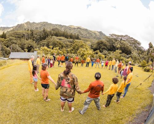 Mai Uka Kuʻu Waʻa keiki join hands in an aloha circle at Hoʻoulu ʻĀina. | Photo by Kaʻōhua Lucas