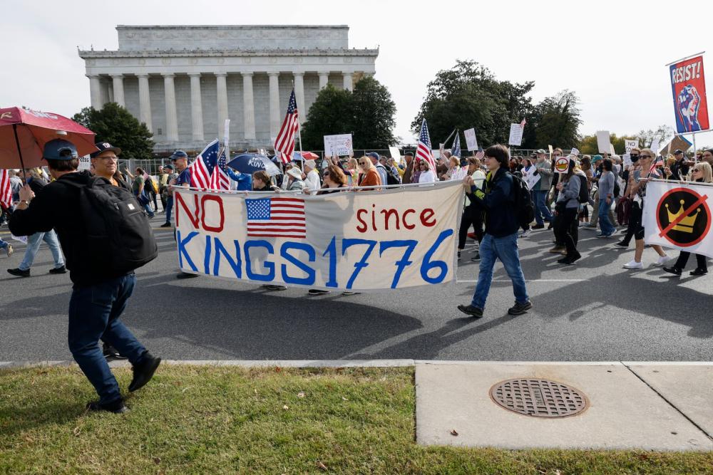 Demonstrators take part in a protest against the Donald Trump administration during the No Kings national rally in Washington, D.C., on Oct. 18, 2025. Millions of people across the nation join the ''No Kings'' protest to demonstrate their disapproval of the current administration. The No Kings Day of Defiance is organized to reject authoritarianism, billionaire-first politics, and the militarization of the country's democracy, according to a statement by organizers.