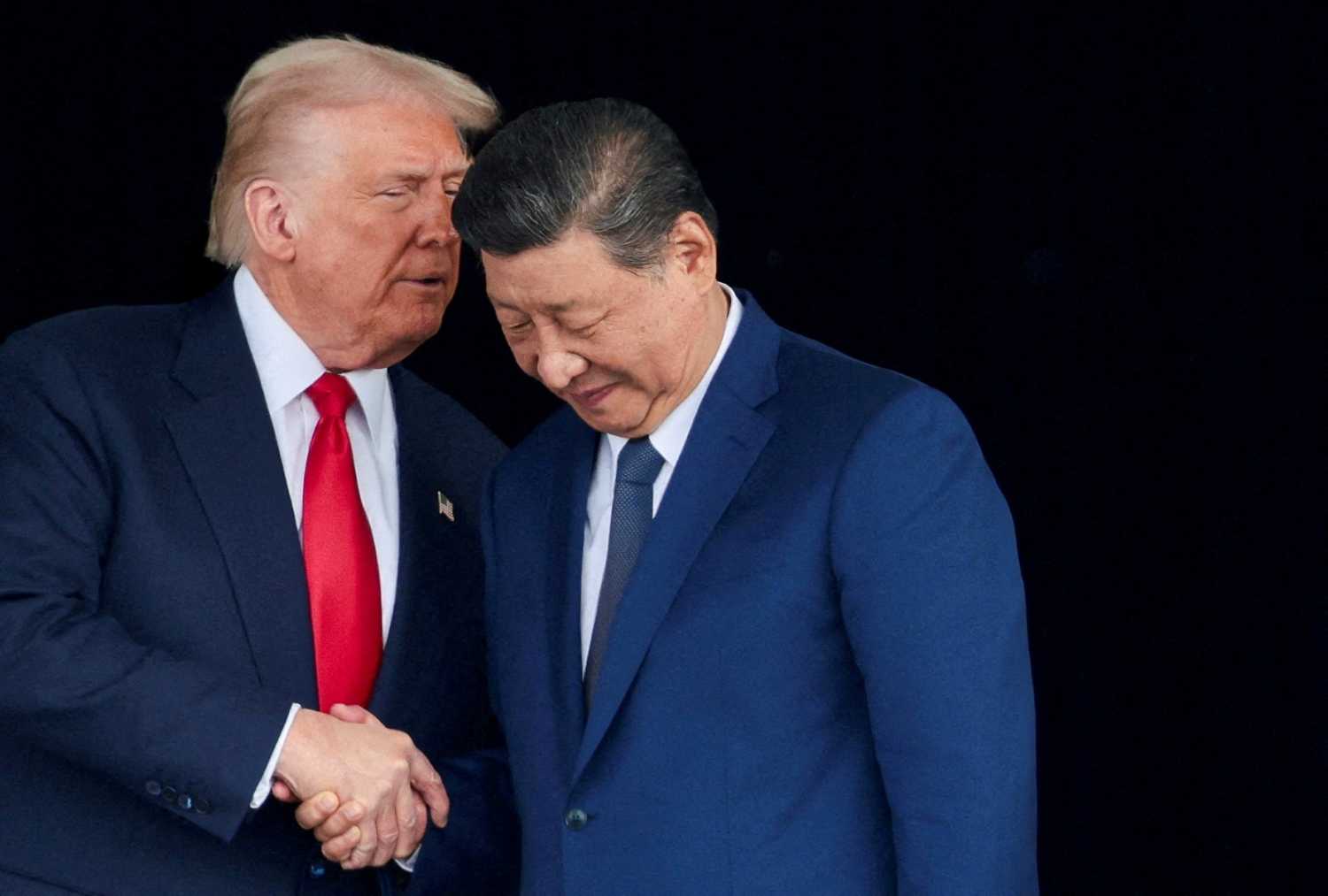 U.S. President Donald Trump and Chinese President Xi Jinping talk as they leave after a bilateral meeting at Gimhae International Airport, on the sidelines of the Asia-Pacific Economic Cooperation (APEC) summit, in Busan, South Korea, October 30, 2025.