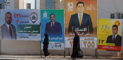 Women walk past campaign posters of candidates ahead of Iraq’s upcoming parliamentary elections in Mosul, Iraq, November 6, 2025.