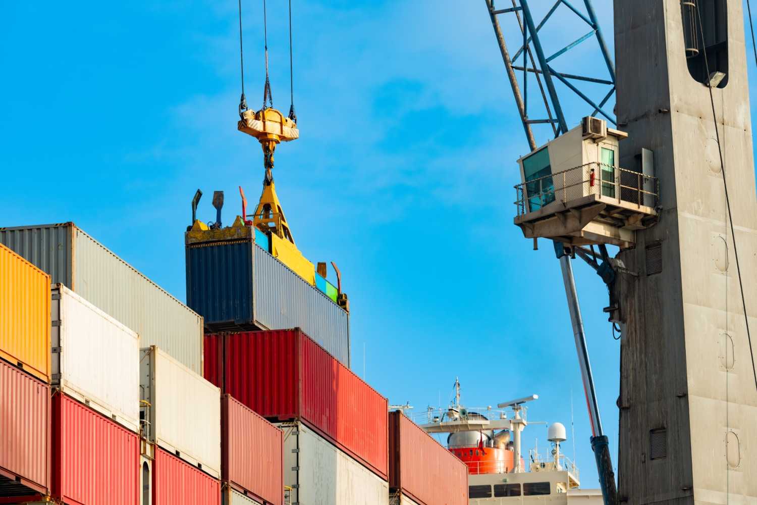 Cargo ship being loaded with containers at trade port