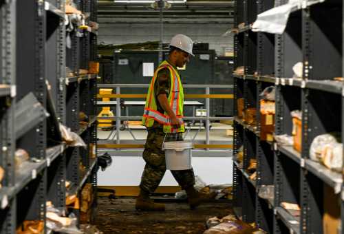 U.S. Airmen with the 735th Supply Chain Operations Group, carry buckets of water at Joint Base Langley-Eustis, Virginia, Mar. 9, 2023.