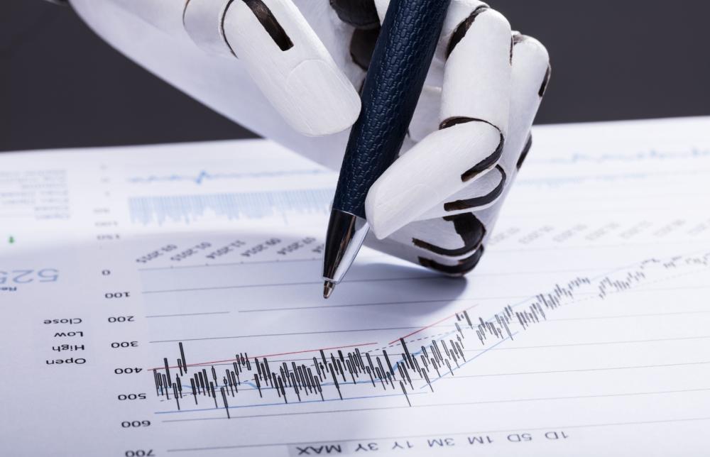 Robot hand holding pen evaluating financial chart