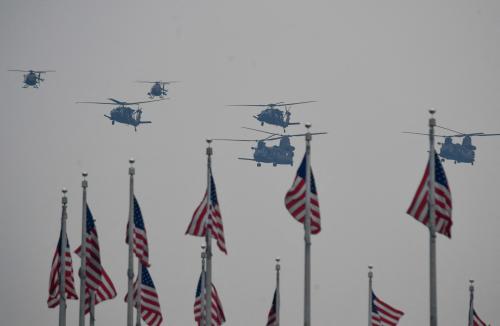 CH-47 Chinook Helicopters fly past US flags at the Washington Monument during the Army 250th Birthday military parade in Washington DC on Saturday, June 14, 2025.