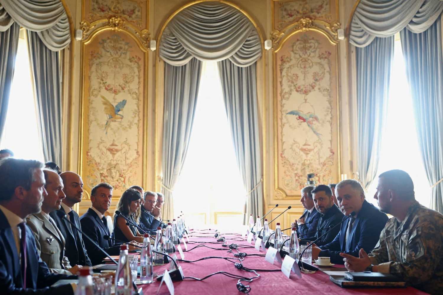 TOPSHOT - Ukraine's President Volodymyr Zelensky (C-R) and France's President Emmanuel Macron (C-L) take part in the Integrated Anti-Ballistic Missile Coalition meeting ahead of a summit of the Coalition of the Willing to support Ukraine at the Hotel des Invalides in Paris on July 13, 2026.