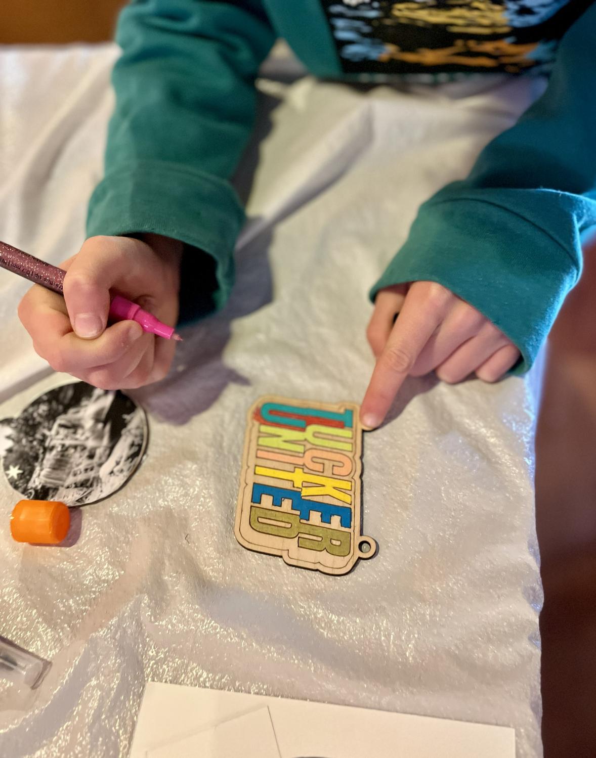 Kid decorating a Christmas ornament during a pizza party