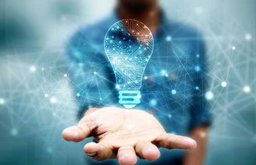 Man holding blue digitally generated light bulb