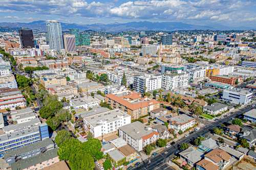Los Angeles, California – October 29, 2024: Aerial drone village home community photo toward LA Koreatown James M Wood Blvd, 8th St, Vermont Ave with streets, apartments, buildings, downtown LA, Wils