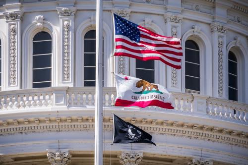 September 22, 2018 Sacaramento / CA / USA - The US flag, the California flag and the POW-MIA flag waving in the wind in front of the Capitol State Building in downtown Sacramento