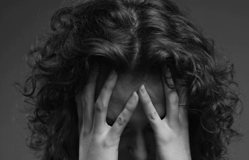 Woman holding her head in despair.