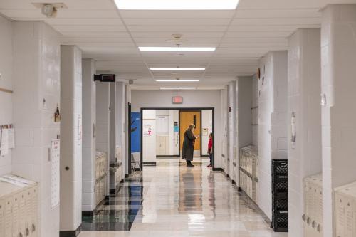 A teacher speaks with one of her students outside of a classroom in a hallway at Carter Traditional Elementary School on Jan. 24, 2022, in Louisville, Kentucky.