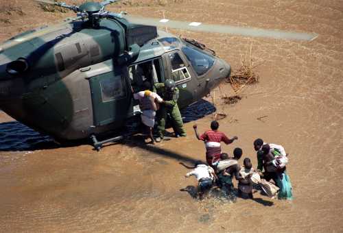 An unidentified family are rescued by a South African army helicopter crew on March 2, 2000 in Tres Febrero, about 100 km north of Maputo, Mozambique.