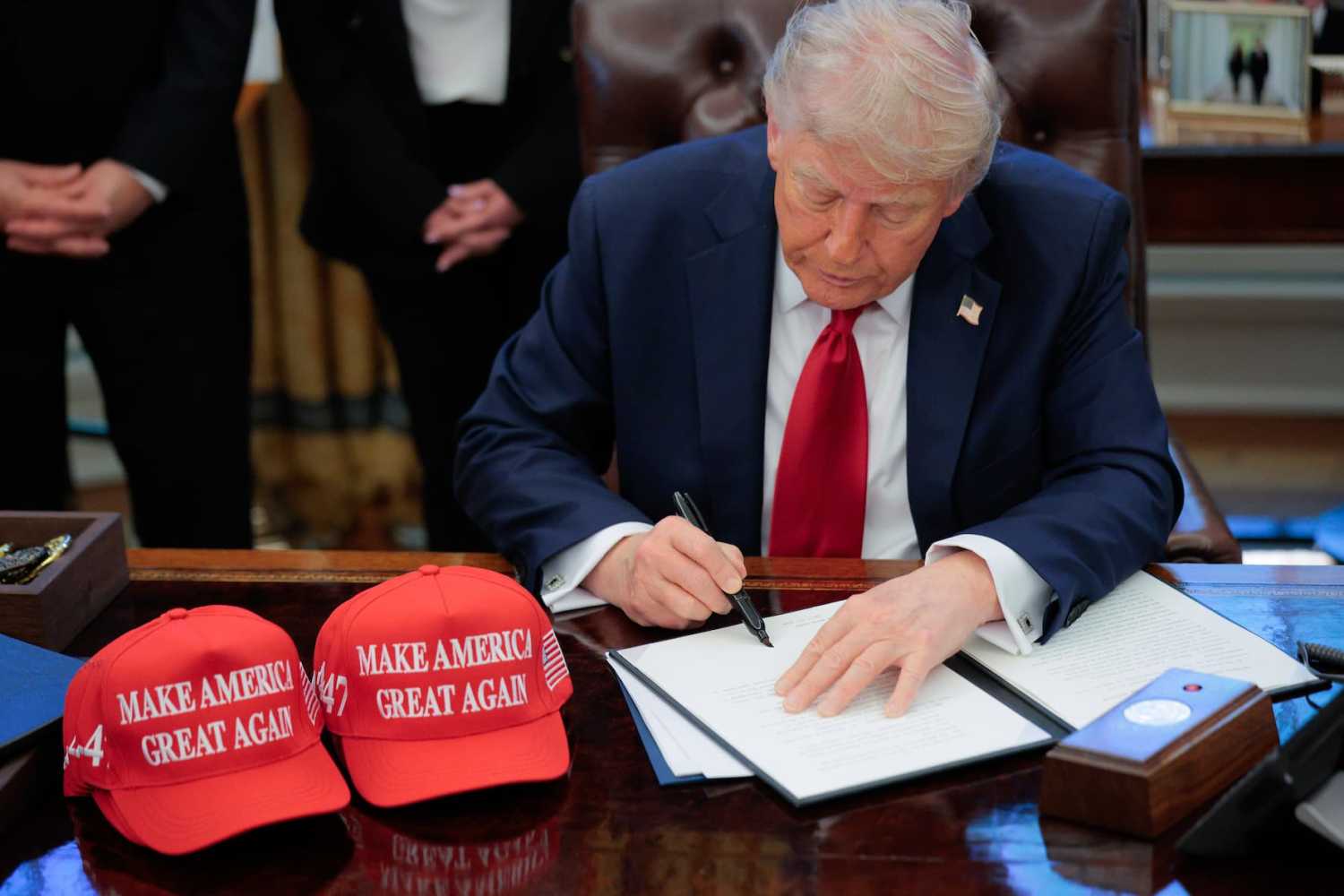 U.S. President Donald Trump signs an executive order in the Oval Office at the White House on April 23, 2025, in Washington, DC. The seven executive orders were related to education policy including enforcing universities to disclose foreign gifts, artificial intelligence education and school disciplinary policies.