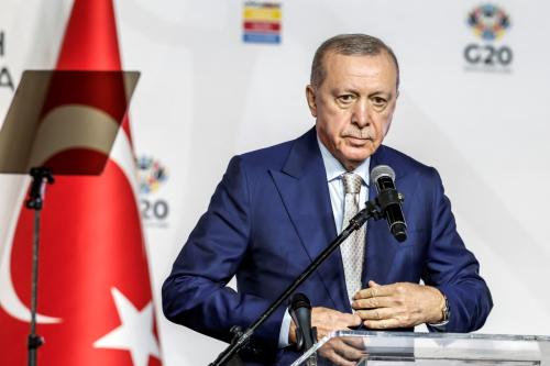 Turkey's President Recep Tayyip Erdogan buttons up his jacket during a press conference after the conclusion of the G20 Leaders' Summit at the Nasrec Expo Centre in Johannesburg on November 23, 2025.