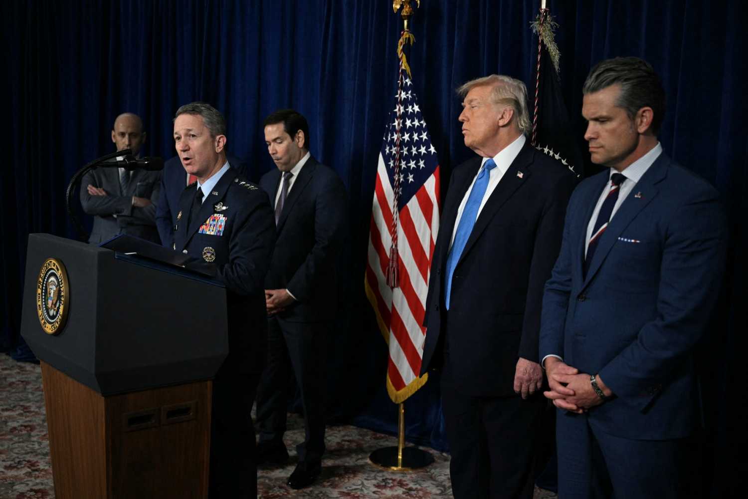 US President Donald Trump (2R) looks on as Chairman of the Joint Chiefs of Staff General Dan Caine (2L) speaks to the press following US military actions in Venezuela, at Trump's Mar-a-Lago residence in Palm Beach, Florida, on January 3, 2026.