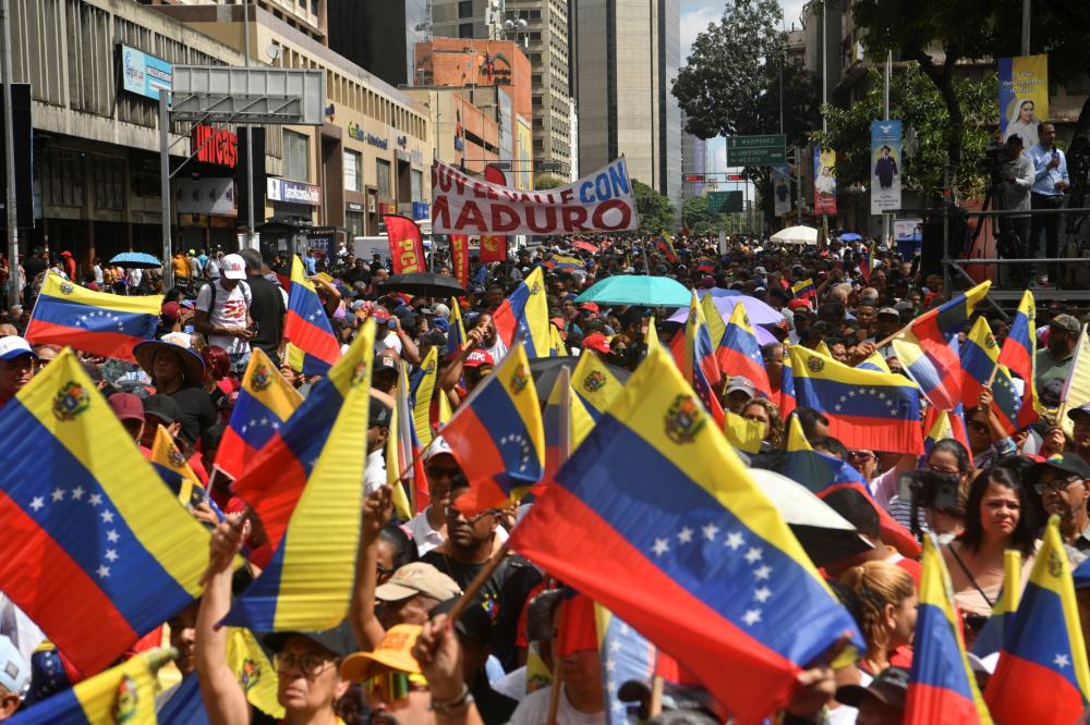 Pro-government supporters attend a rally a day after the capture of Nicolas Maduro by US forces on January 4, 2026 in Caracas, Venezuela.