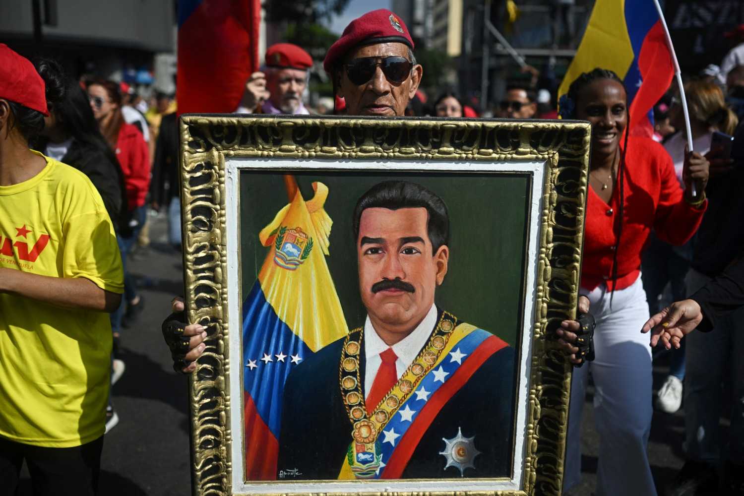 A man holds a picture of ousted Venezuelan President Nicolas Maduro during a rally in support of Maduro and his wife, Cilia Flores, in Caracas on January 6, 2026.