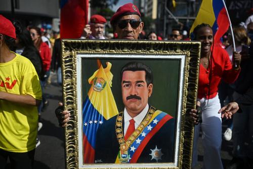 A man holds a picture of ousted Venezuelan President Nicolas Maduro during a rally in support of Maduro and his wife, Cilia Flores, in Caracas on January 6, 2026.